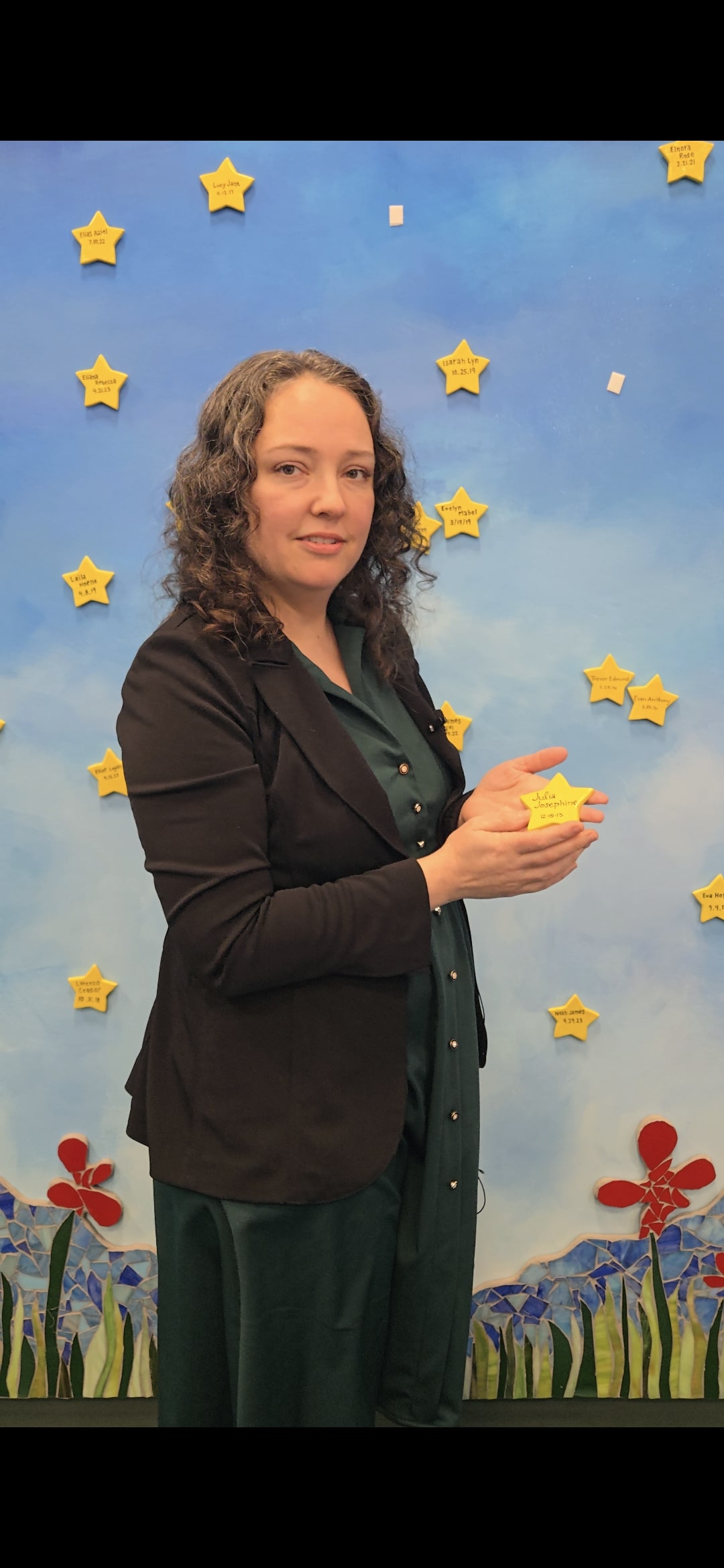 Woman holds a star in memory of her niece Julia